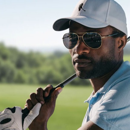 Man wearing a golf hat with the Me Crush logo (a unique golf apparel, gift and accessory brand) embroidered on its center.