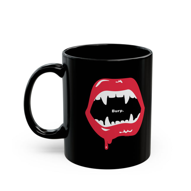 Burp Fangs black mug 11oz, lifestyle shot on desk — funny vampire Halloween coffee mug