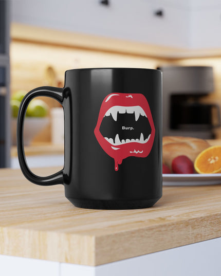 Burp Fangs black ceramic mug 15oz, studio shot — spooky funny coffee mug