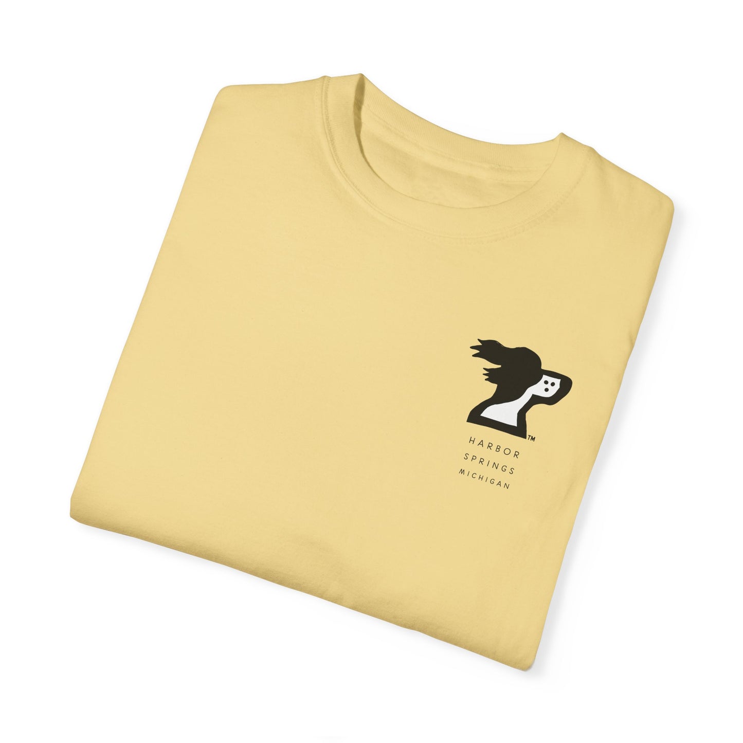 Folded light yellow color t-shirt by the Harbor Springer brand with a springer spaniel dog logo and Harbor Springs Michigan text.