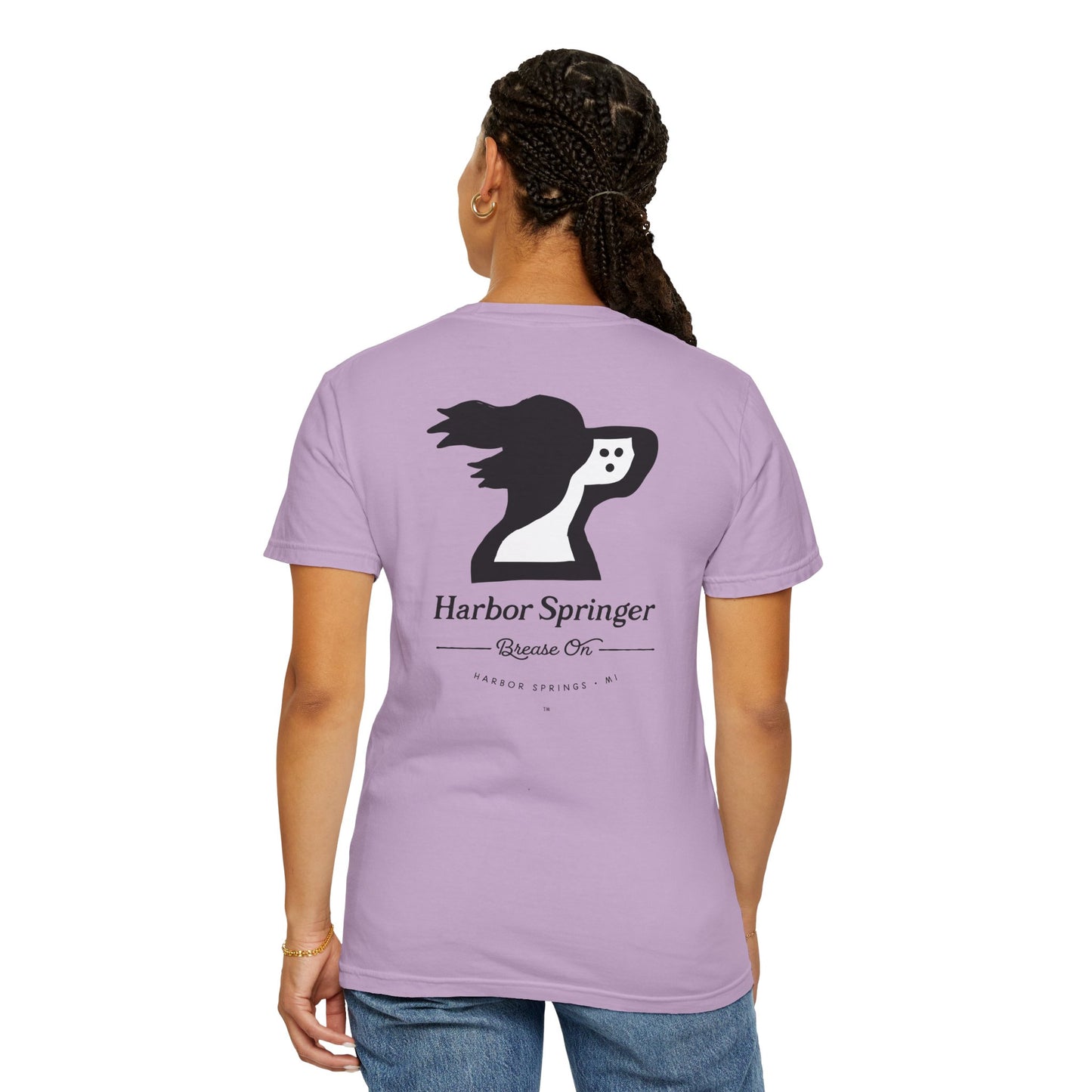 Woman wearing purple color t-shirt by the Harbor Springer brand with a springer spaniel dog logo and Brease On tagline on the back.