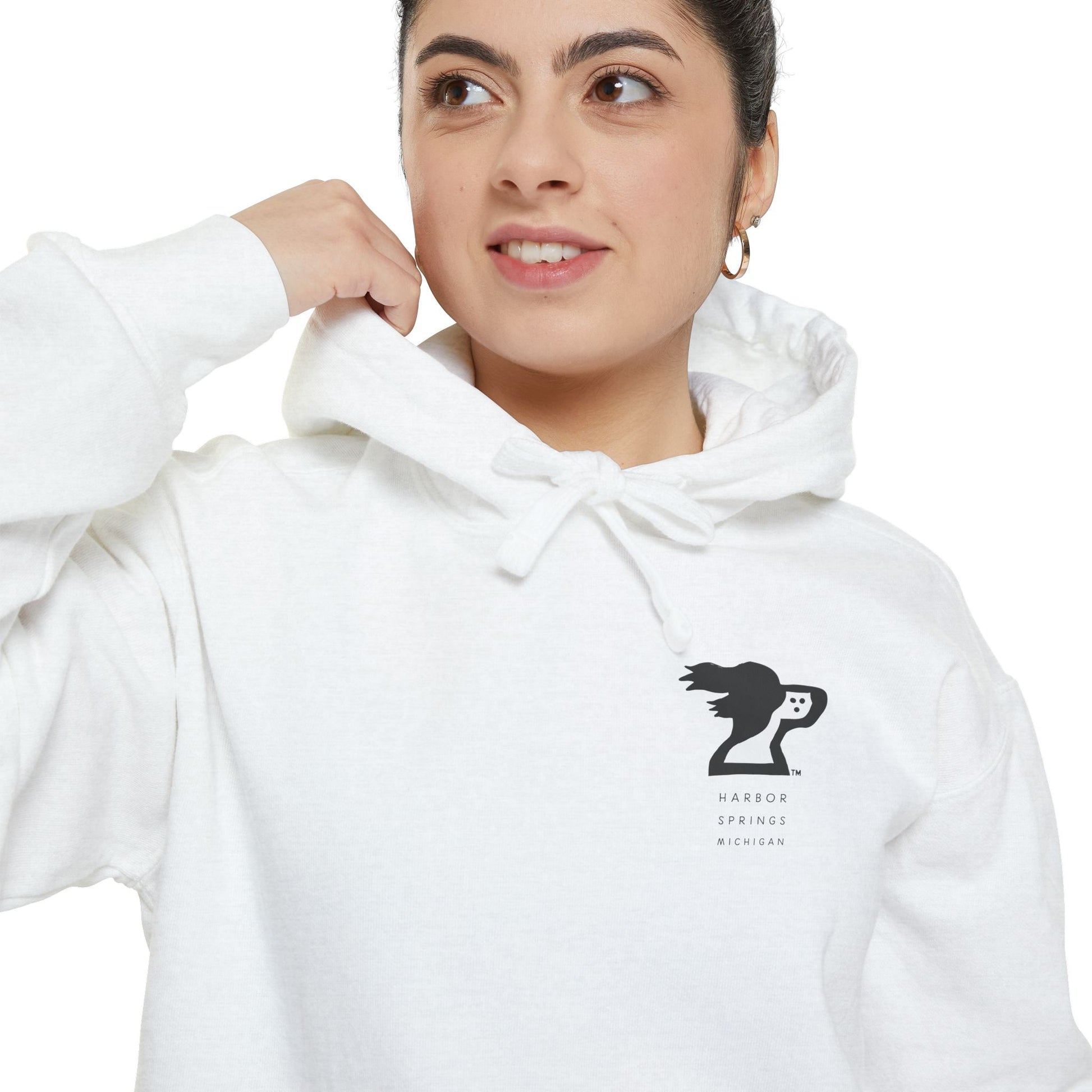 Woman wearing white color hoodie by the Harbor Springer brand with a springer spaniel dog logo and Harbor Springs Michigan text.