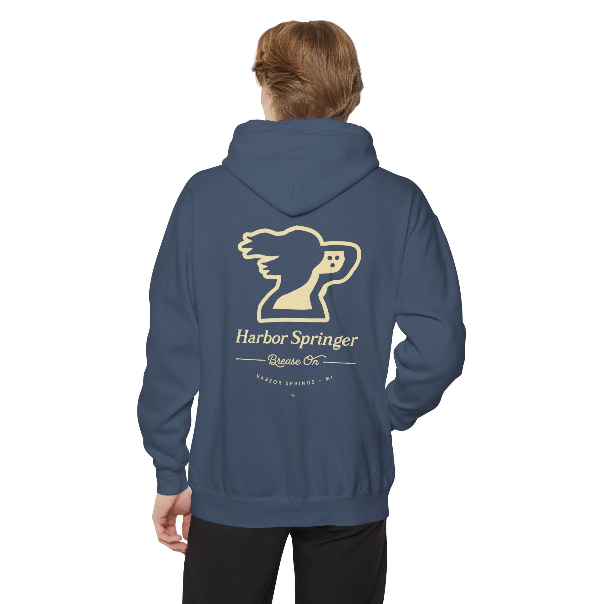 Man wearing blue hoodie by the Harbor Springer brand with a springer spaniel dog logo and Brease On tagline on the back.