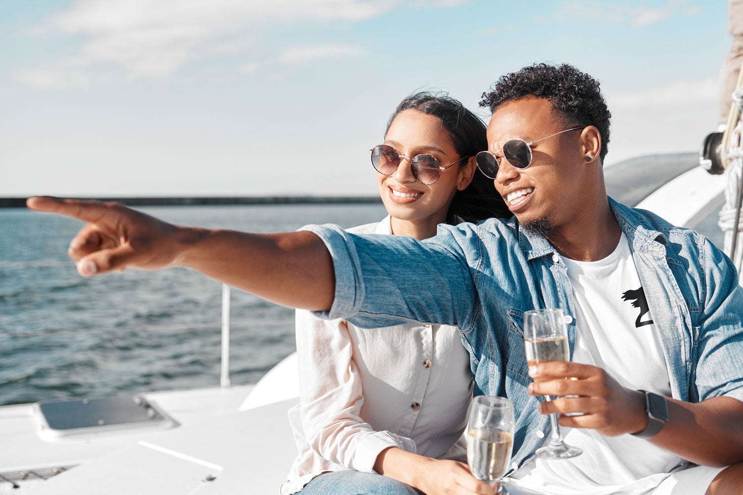 Couple on yacht wearing Harbor Springer logo clothing