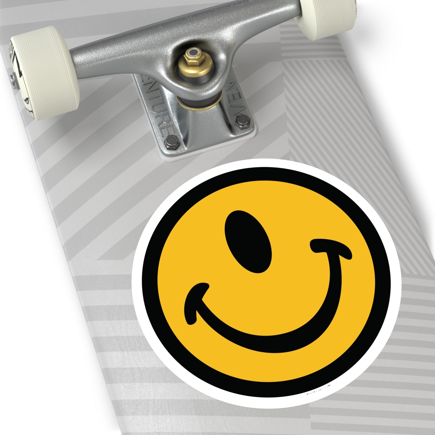 Jumbo one-eyed smile face round sticker by the Smileclops™ brand on a skateboard.